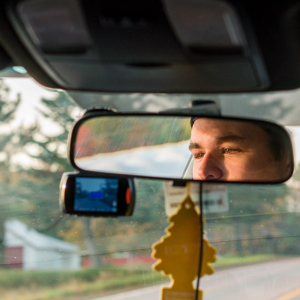 Dovico's Ryan Chitty driving with his face in the rear-view mirror.